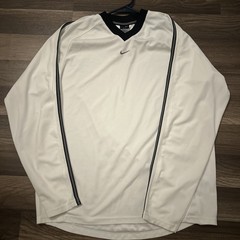 Nike jersey-style v-neck shirt in white with black trim and an embroidered Nike