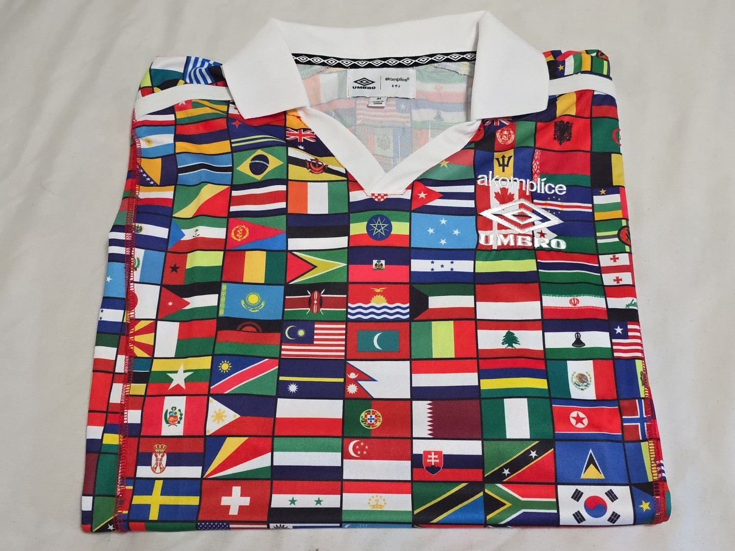 NEW Akomplice X Umbro Vibrant WORLD FLAGS Embroidered PEACE DOVE L/S Polo Jersey gallery